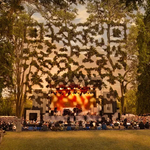 AI QR code art of an open-air concert stage at sunset — scans to the ZapQR gallery